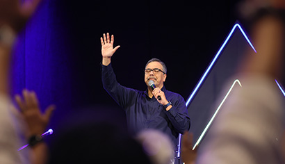 Duane Munoz on stage praying